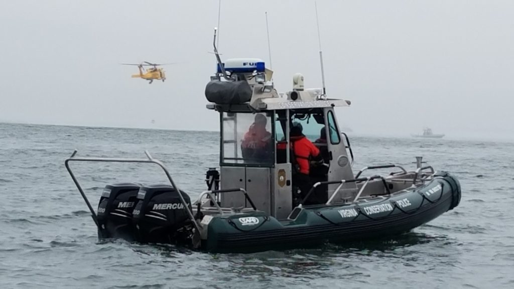 An image of a police boat with a green base and white top