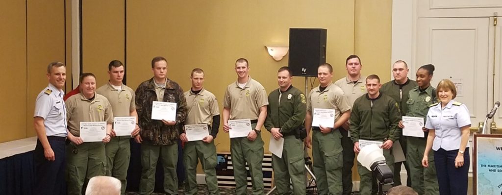 An image of multiple officers holding certificates posing for a picture