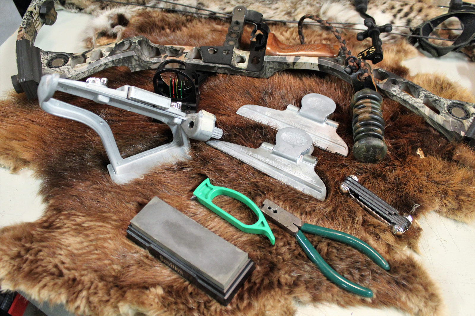 An image of a punch of hunting gear on a pelt