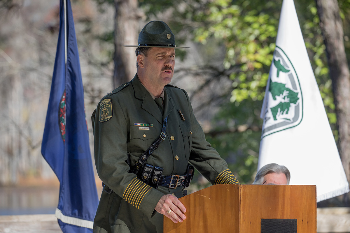 An image of DWR Chief of Law Enforcement, Colonel John J. Cobb, speaking from a wooden lectern at the ceremony