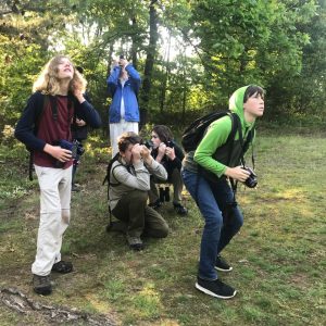 An image of five young birders in the field