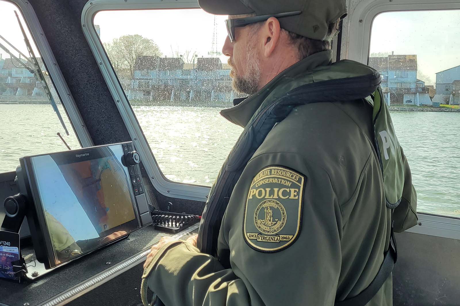 A Conservation Police Officer operating a boat