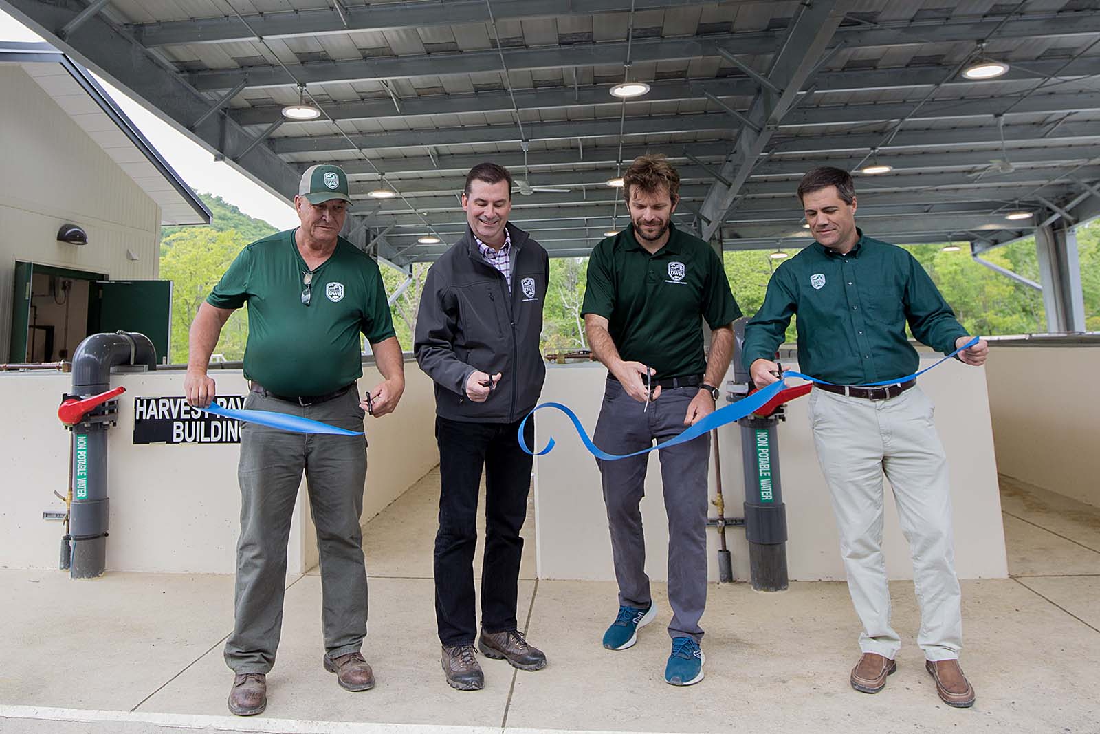 DWR agency officials cutting a ribbon for the re-opening of the newly-renovated Front Royal Fish Hatchery