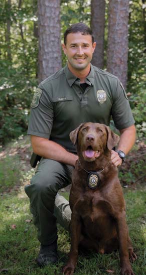 A photo of the K9 and CPO handler