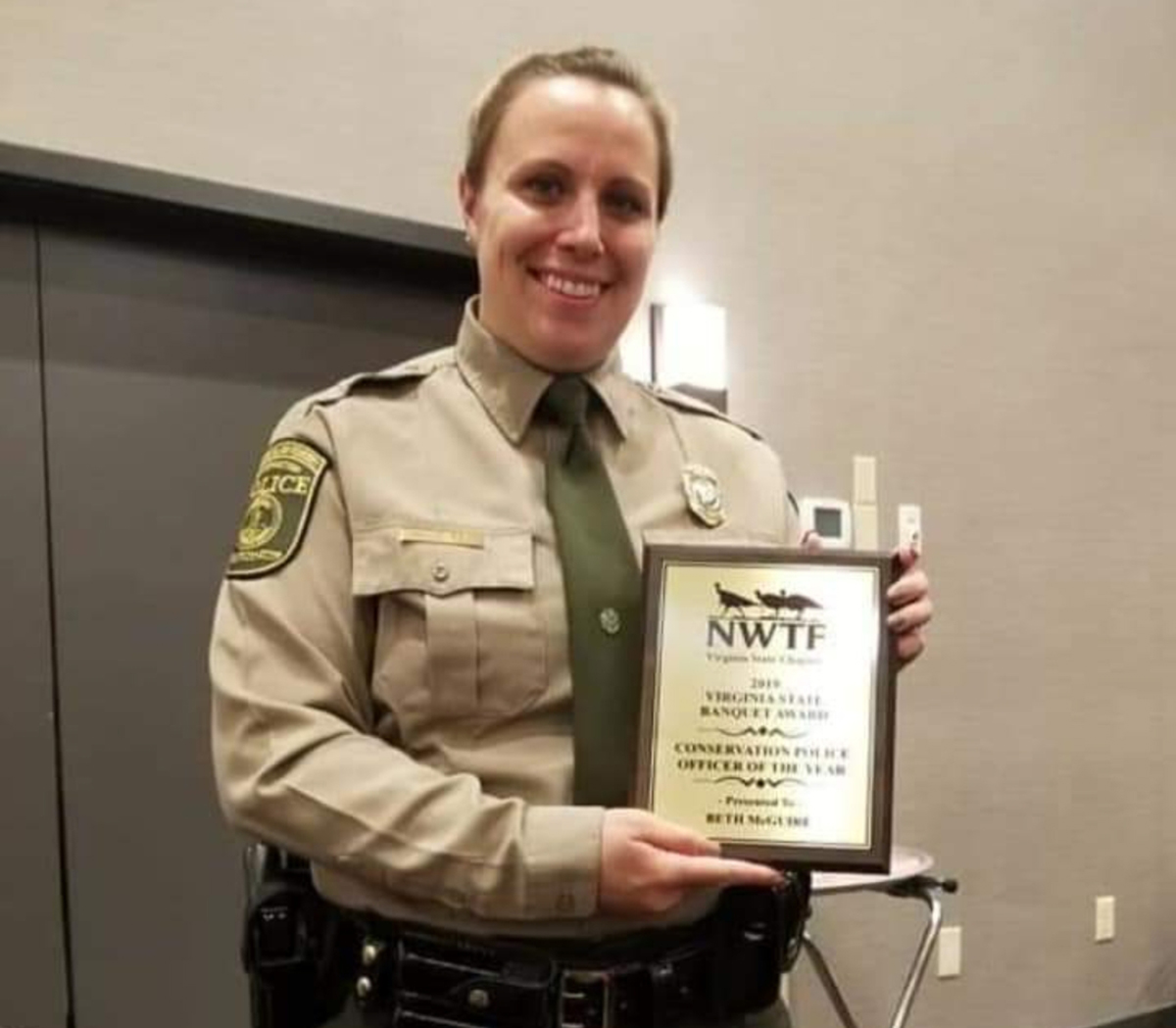 Senior CPO Beth McGuire holding a award she has won for her service