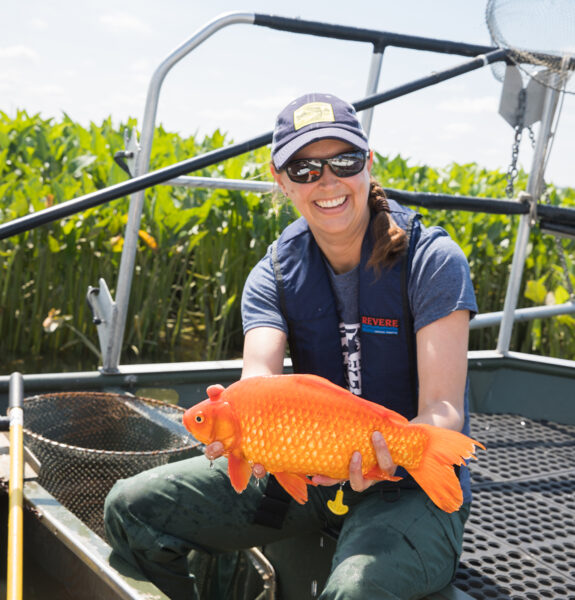An image of a biologist holding a red snapper and smiling, the information collected with electrofishing helps DWR staff with their management decisions for local fish populations.