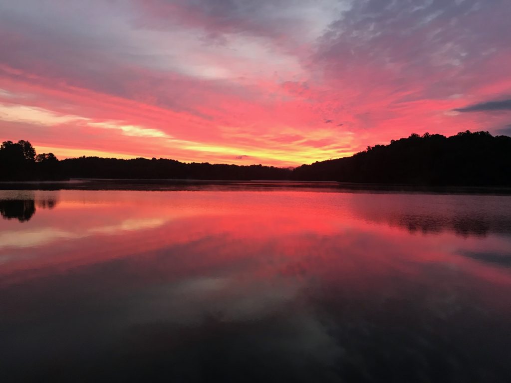 An image of a beautiful red sunset over a lake