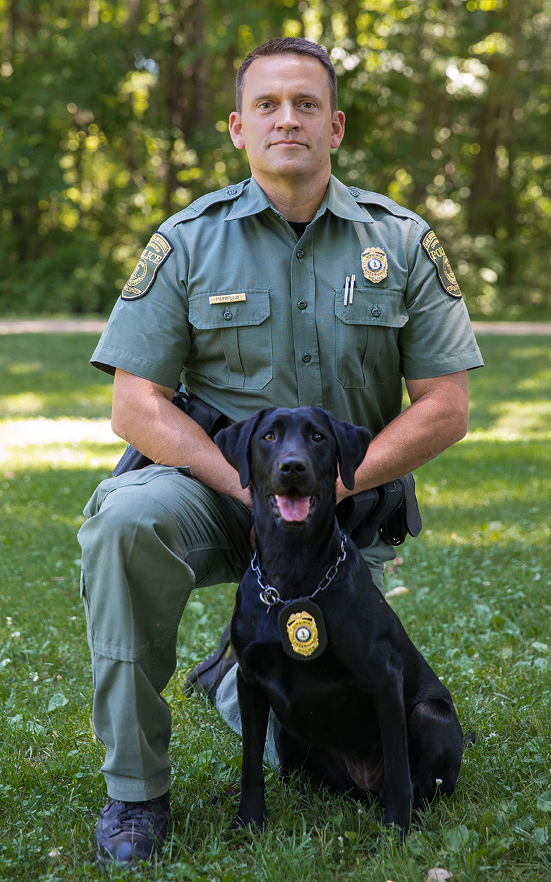 An image of James Patrillo and his K9 officer a black lab named Bailey