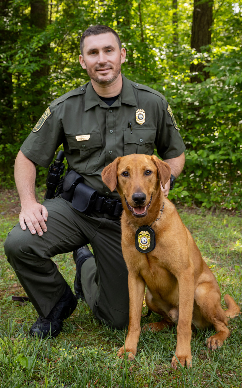 Officer Young and his copper colored lab Blaze