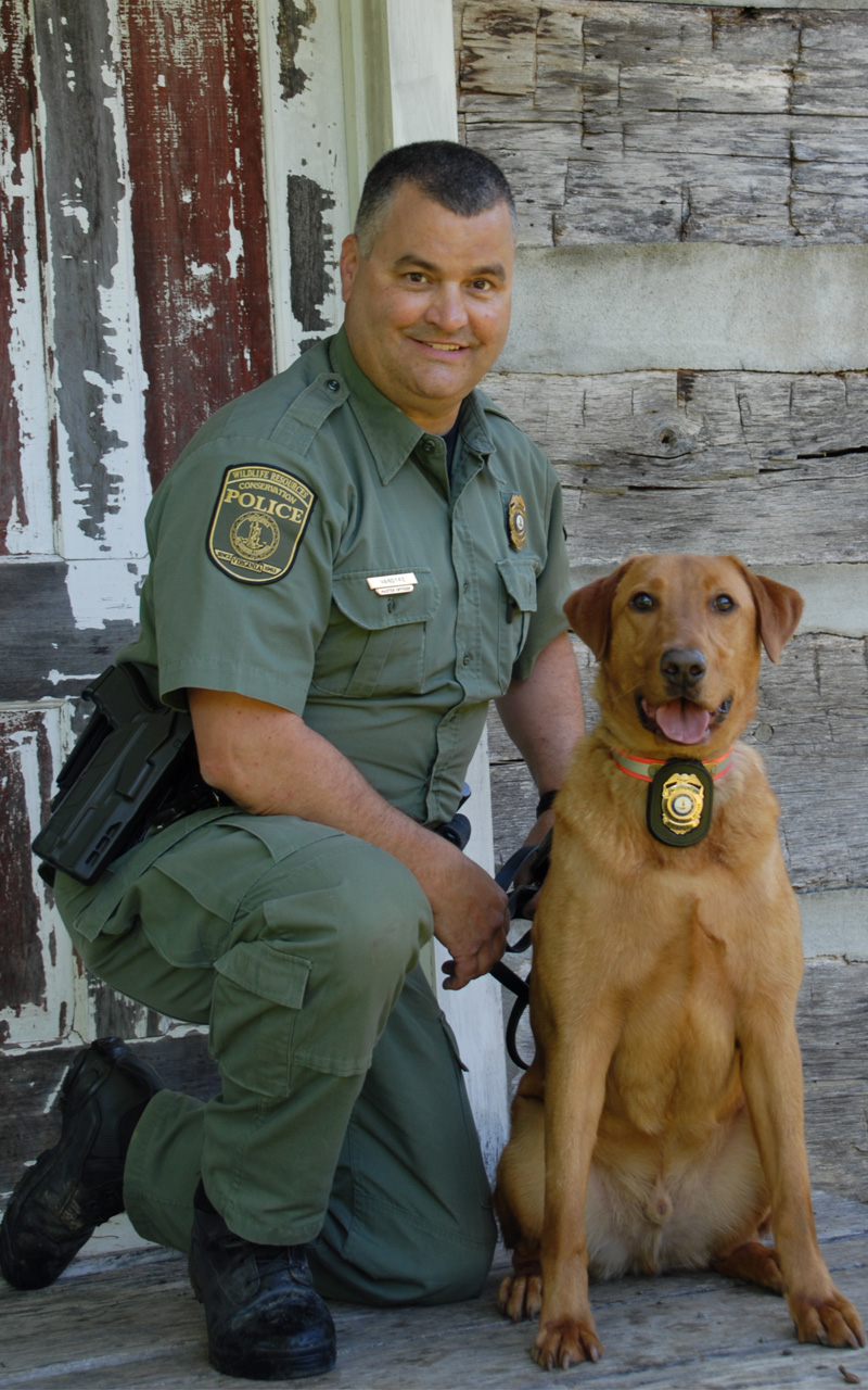 An image of Mark VanDyke and his K9 officer a red lab named Coal