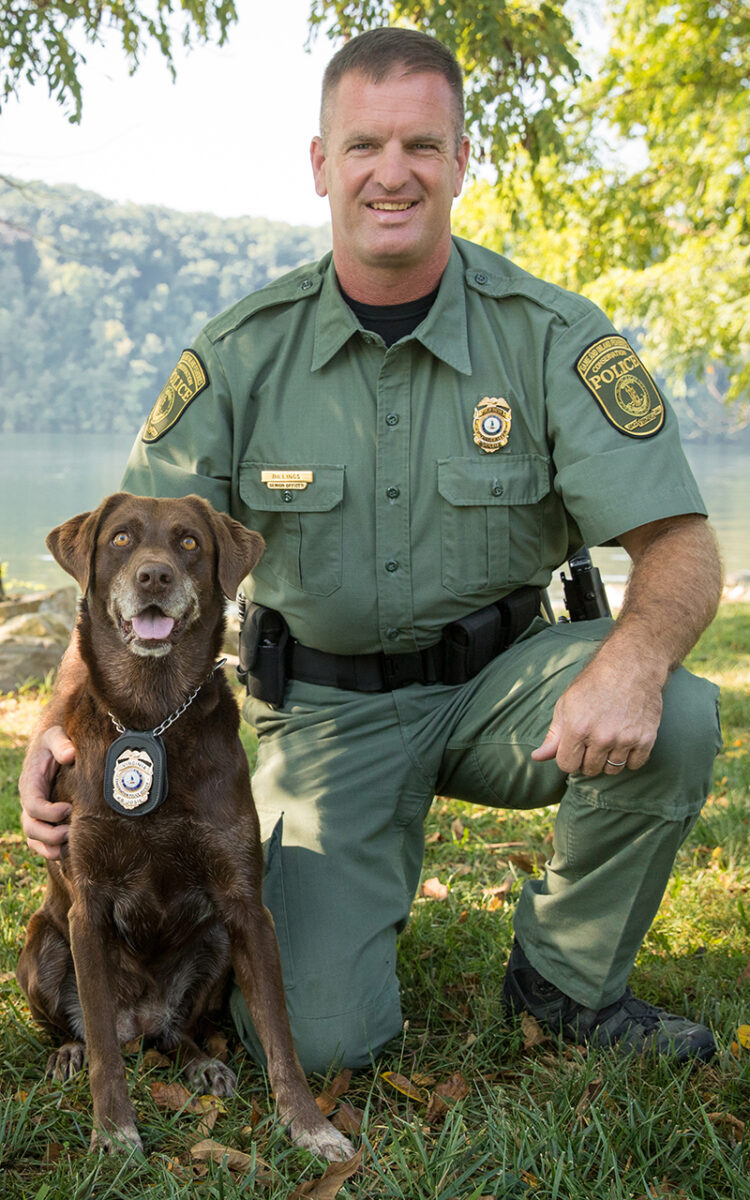 An image of Wes Billings and his retired K9 officer a chocolate lab named Josie