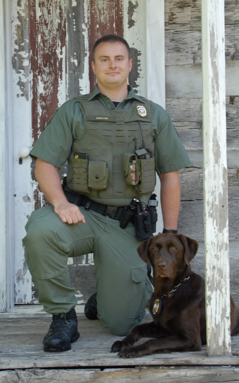 An image of Jacob Chaffin and his K9 officer a chocolate lab named Molly
