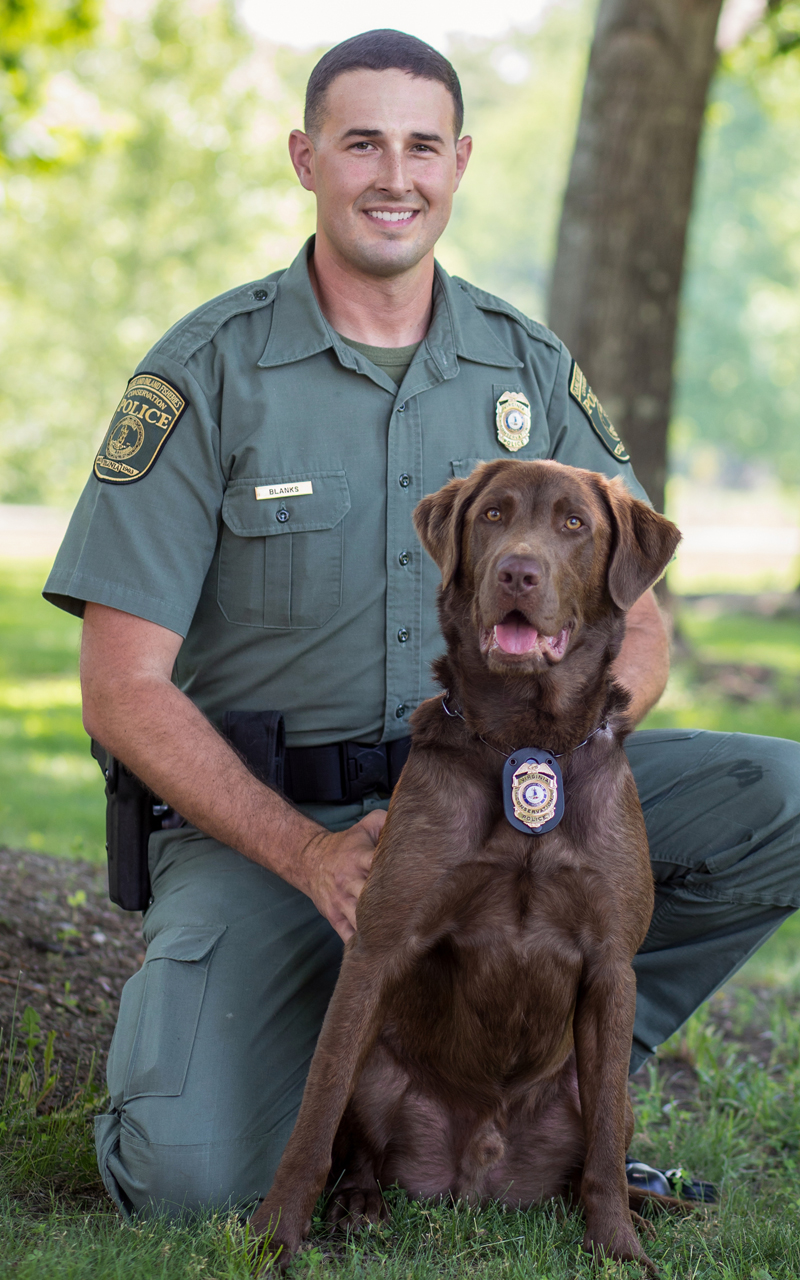 An image of Tyler Blanks and his K9 officer a chocolate lab named Bruno