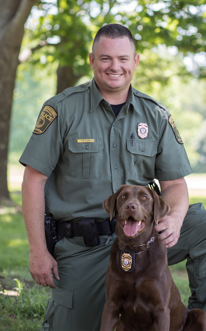 An image of Ian Ostlund and his K9 officer a chocolate lab named Reese