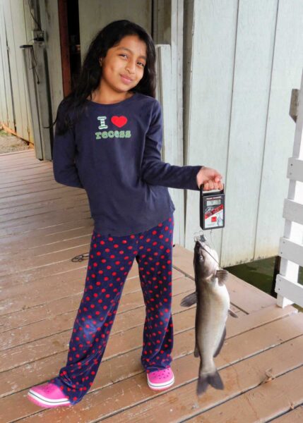 Sophia (age 9), holding a fish