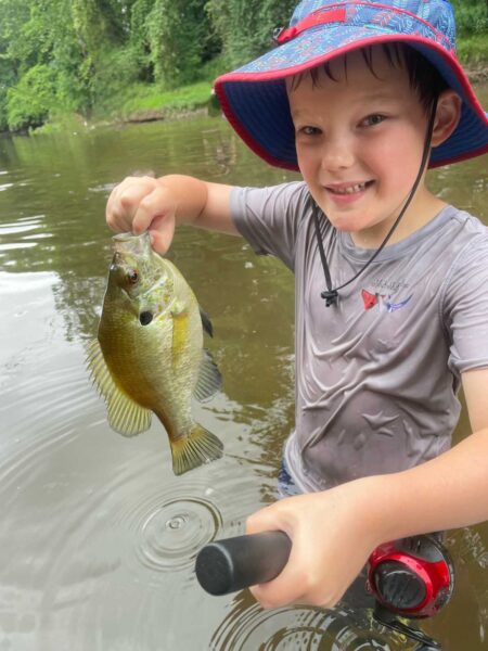 Rowan (age 7), holding a fish