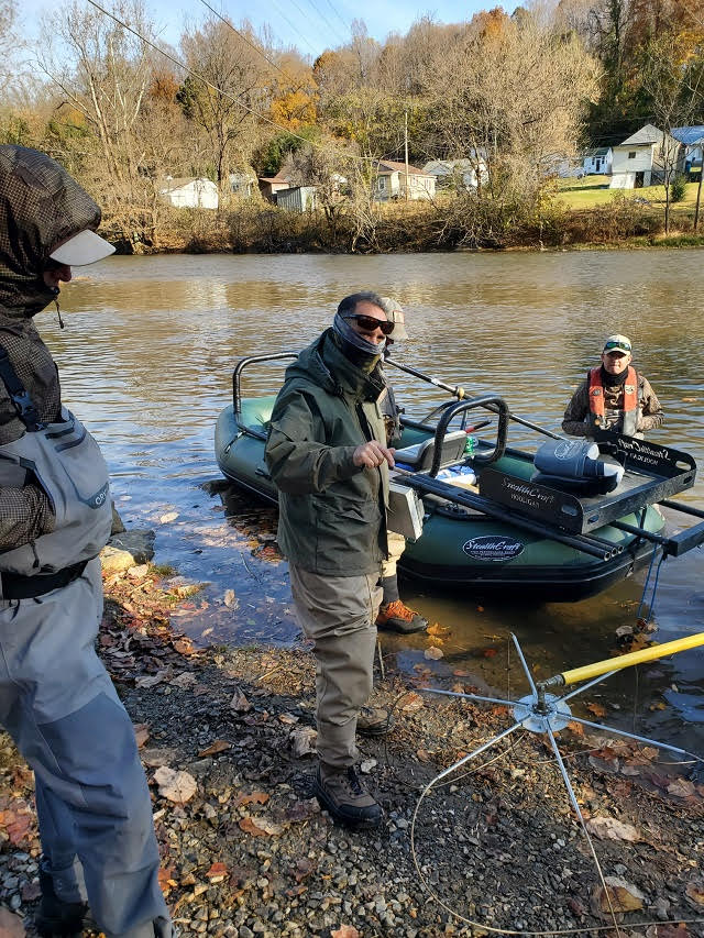 Four men around the electrofishing boat dressed for cold weather during this fall fish sampling