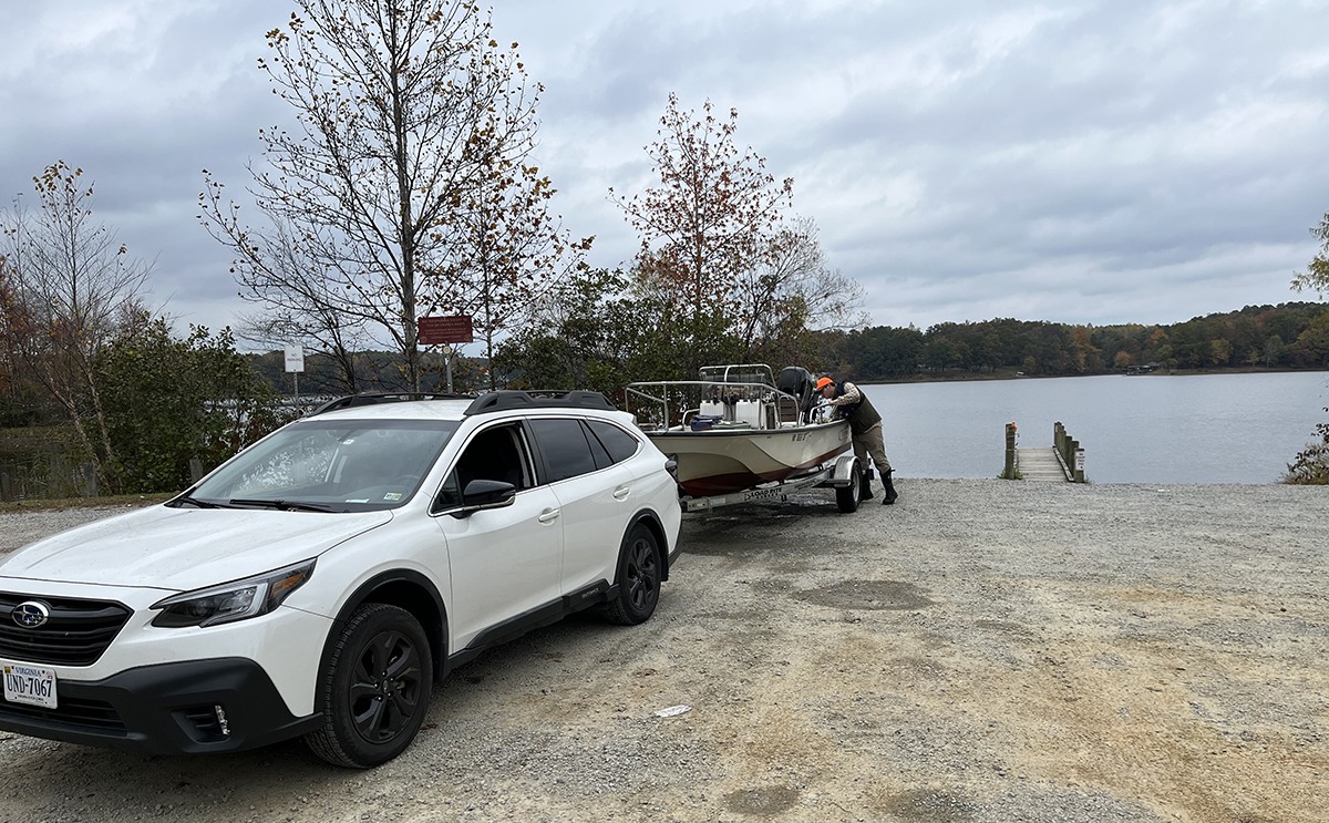 An image of a car at a boating access lowering a motorboat into Lake Chesdin
