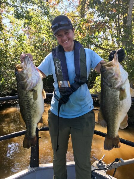 Tidal Rivers Project Leader Margi Whitmore with two sizeable Largemouth Bass.