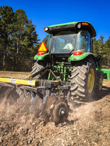 An image of a tractor tilling the ground