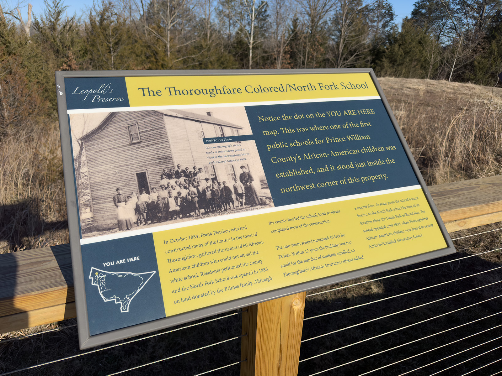 A photo of an interpretive sign titled The Thoroughfare Colored/North Fork School.