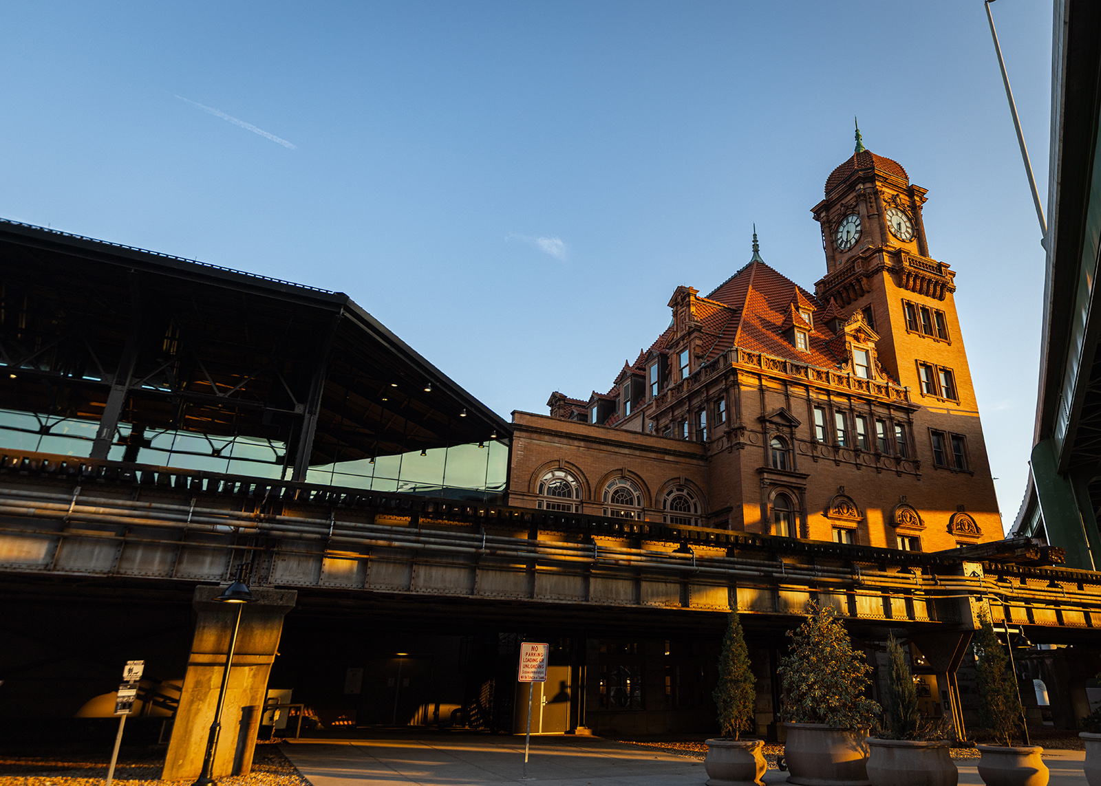 A photo of the exterior of a historic railroad station at sunset.