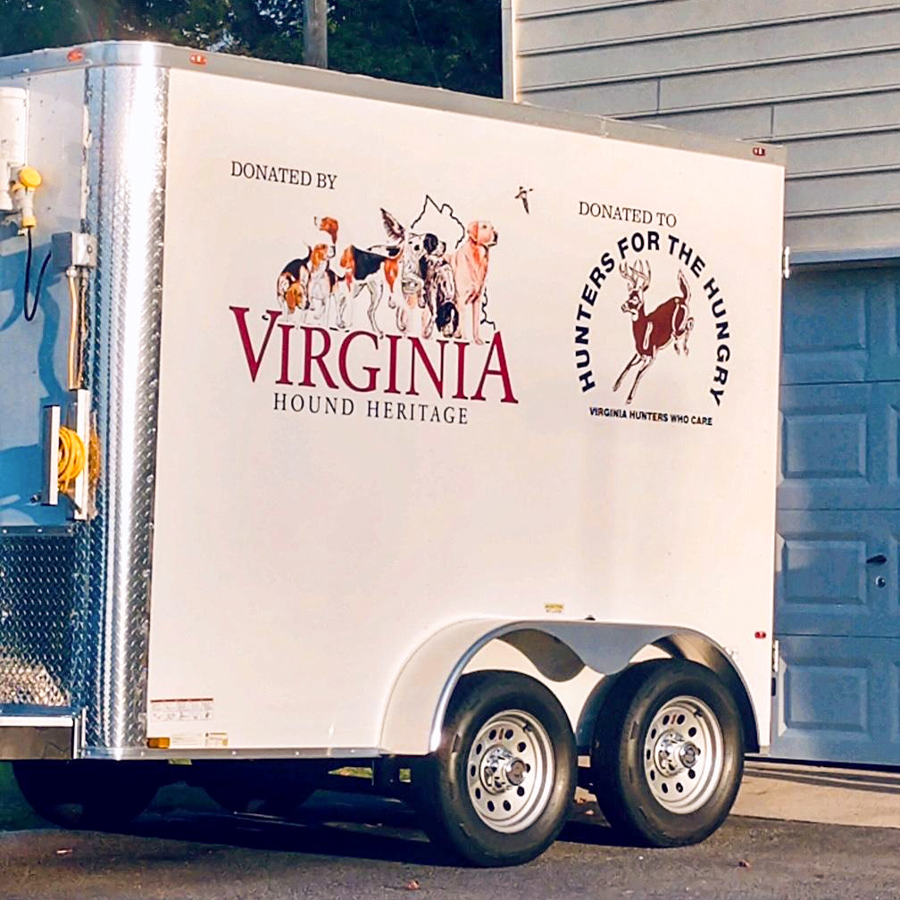 A photo of a refrigerated trailer with logos of Hunters for the Hungry and Virginia Hound Heritage painted on the side.