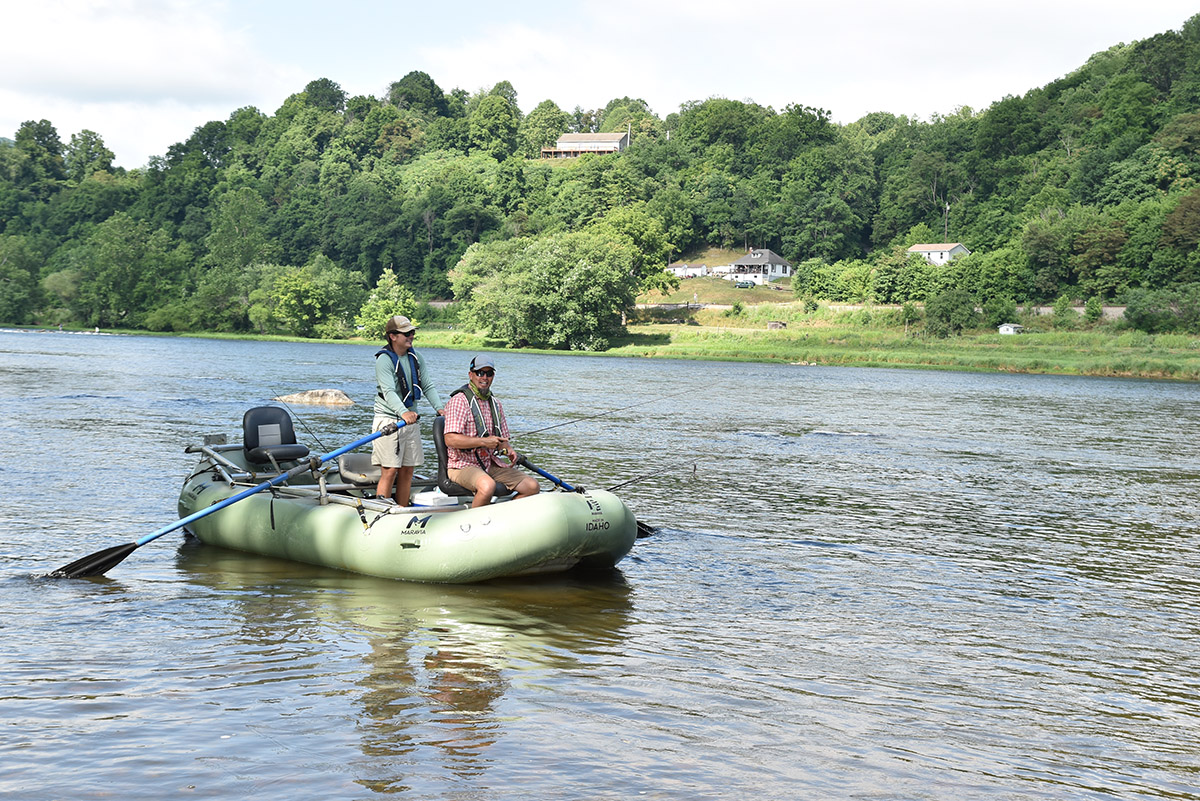 Two men on a green raft in the lower New river