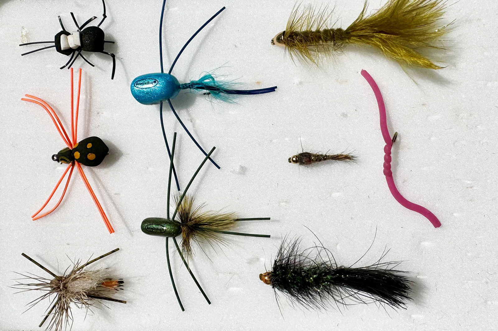 A photo of nine different fishing flies.