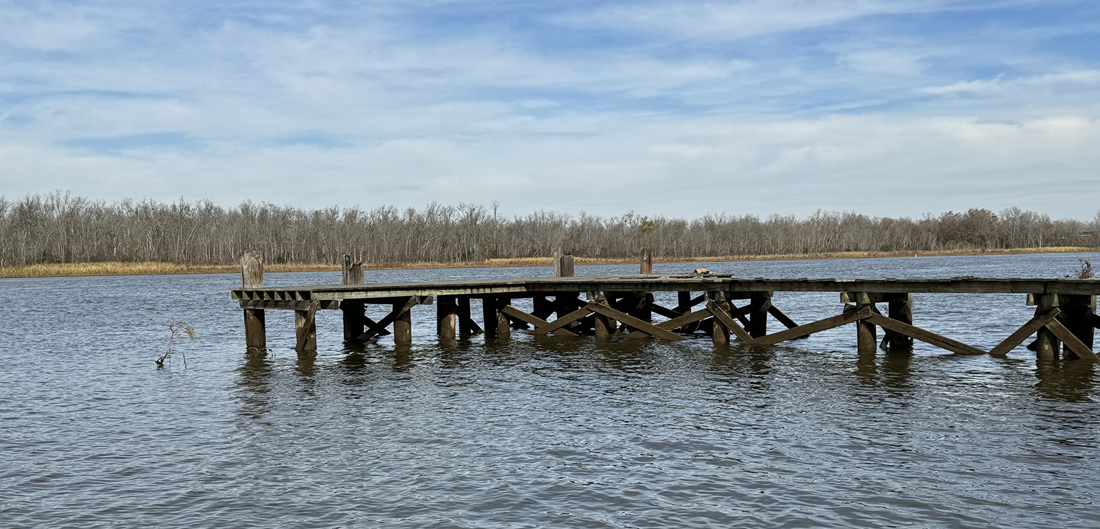 A photo of a large wooden dock set in a river.