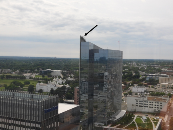 Dominion building as seen by the naked eye. The black arrow indicates Red's location.