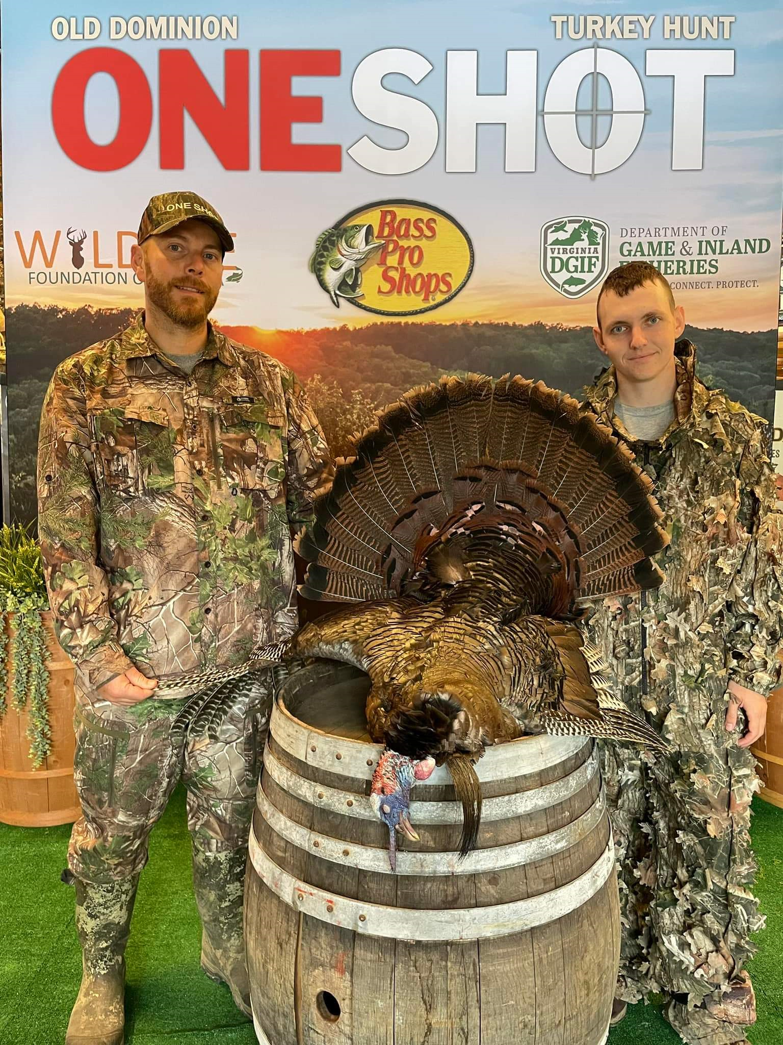 An image of two hunters posing on the front of a magazine with a turkey they had killed