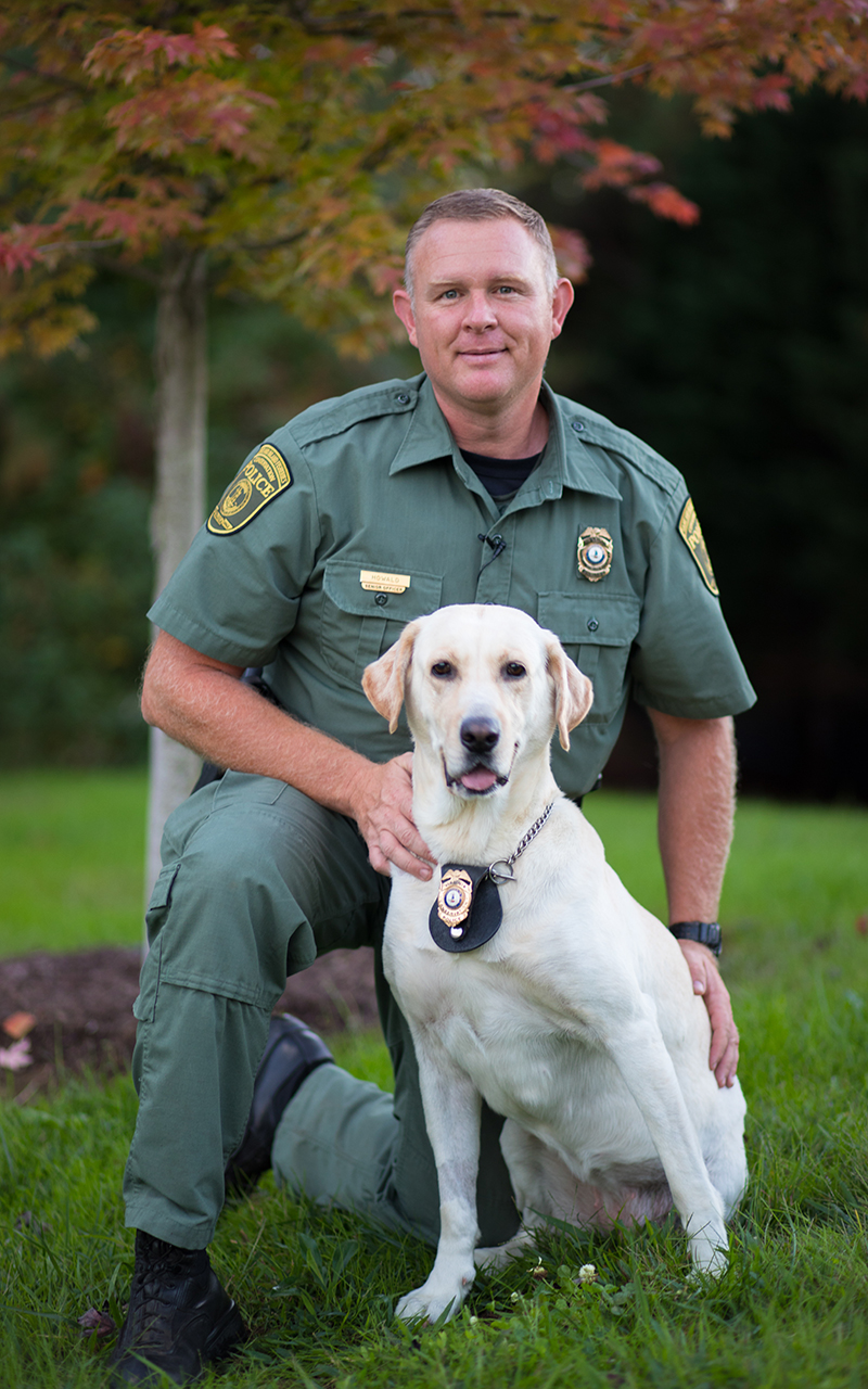 An image of Richard Howald and his retired K9 officer a yellow lab named Scout