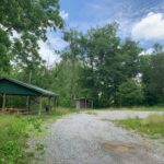 Gravel driveway with a shelter on the left side