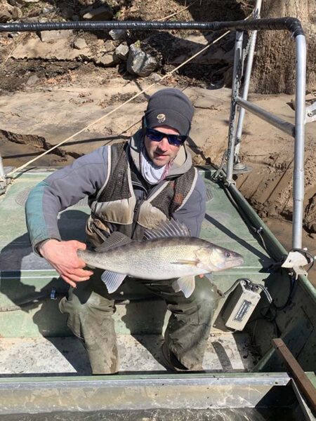A DWR fisheries biologist holds a fish