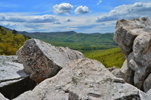 An image of a mountainous rock formation known as Devil's Marbleyard and the mountains visible in the background